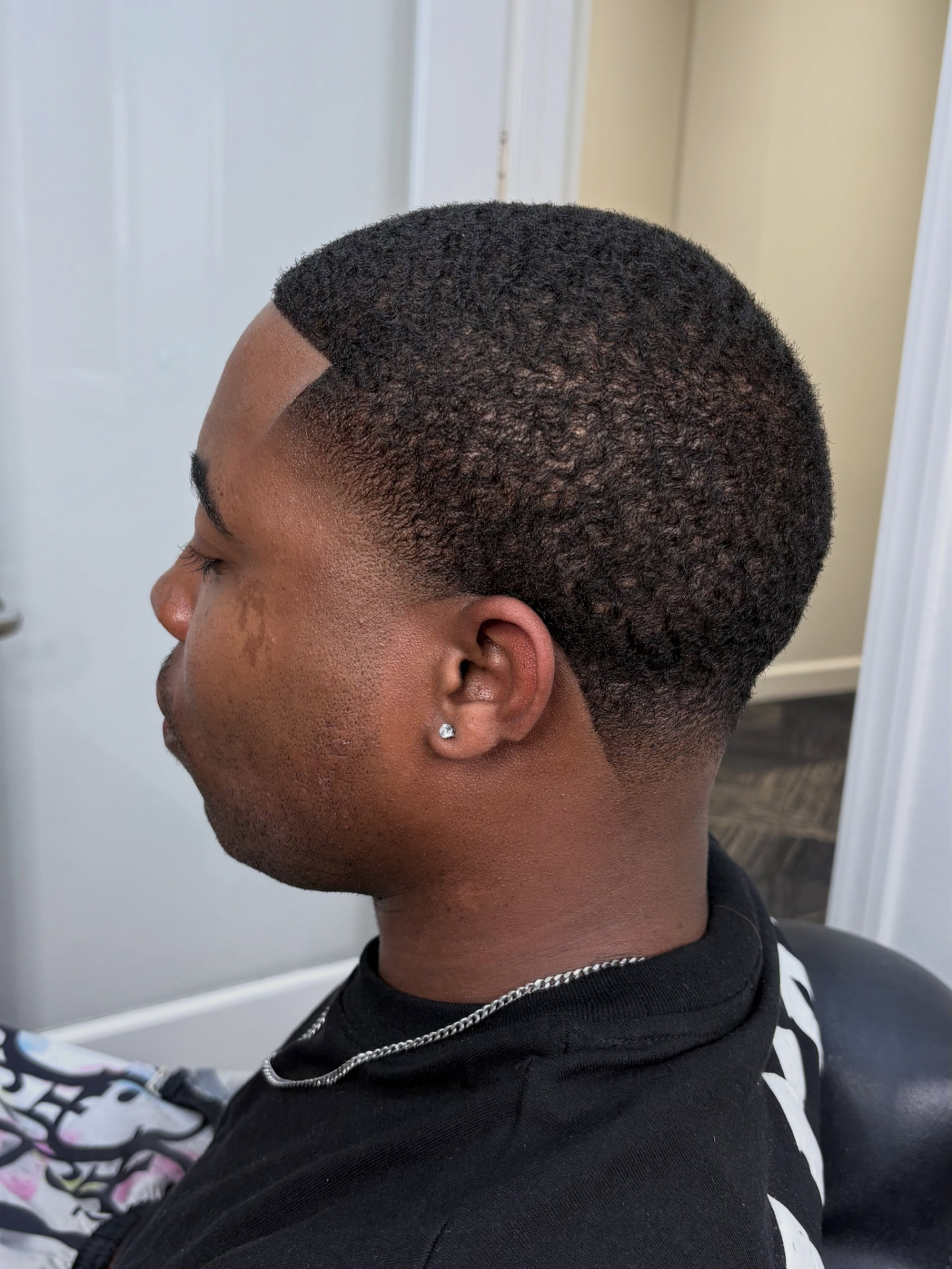 Low taper fade with a sharp line-up, National City barber