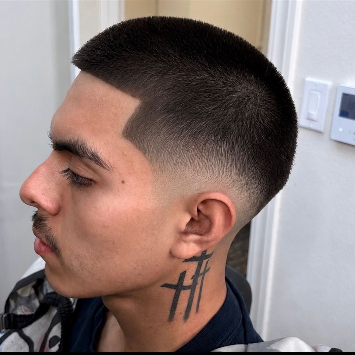 Buzz cut with a sharp part and skin fade, San Diego barber at Die4Fadez Barbershop