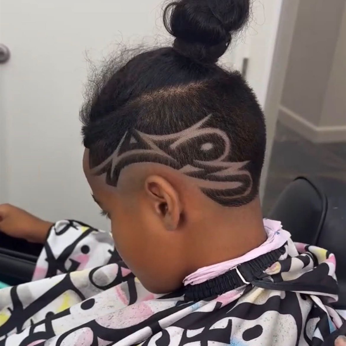 Freestyle tribal hair design shaved into a top knot fade, San Diego barber