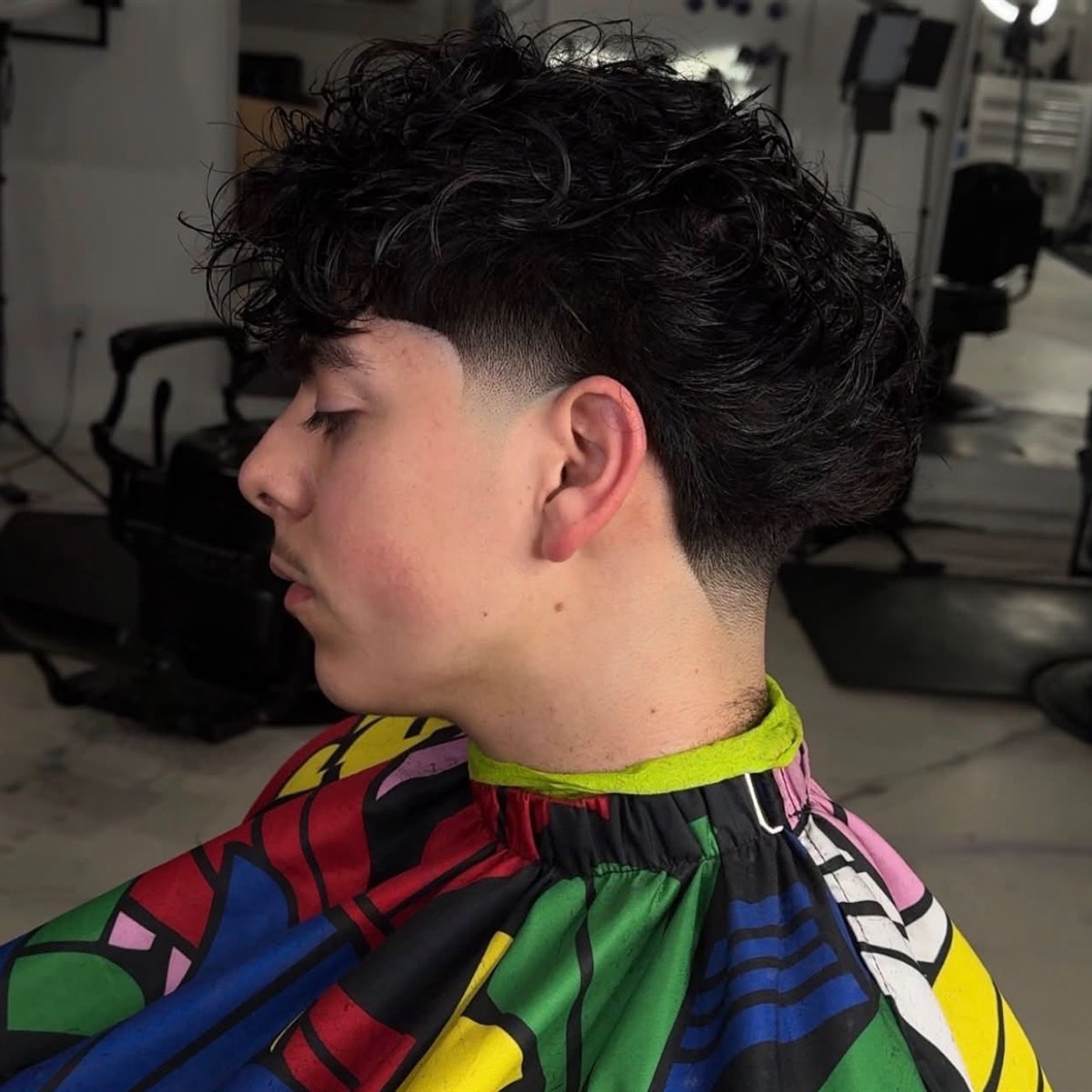 Textured curly fringe with a low taper fade, San Diego barber