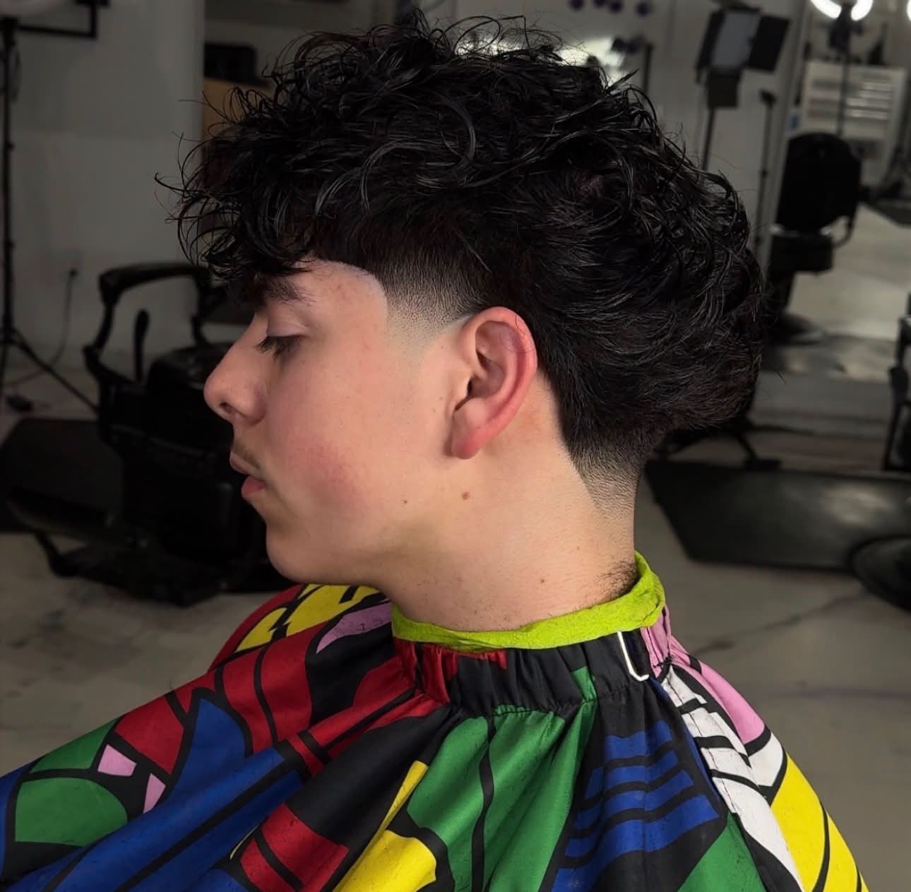 Textured curly fringe with a low taper fade, Die4Fadez Barbershop client in National City, CA